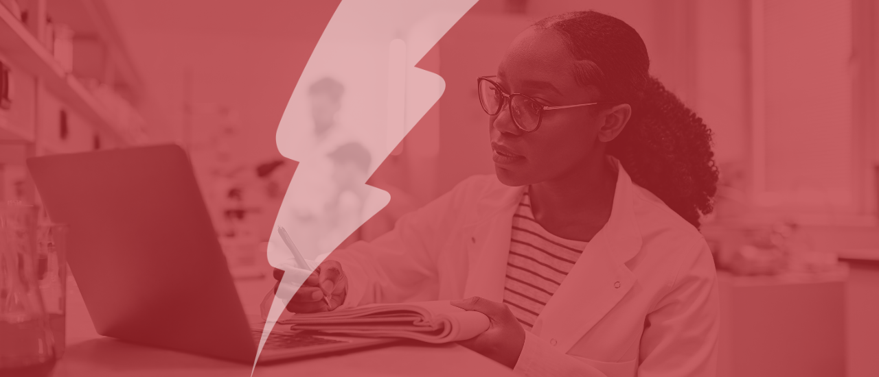 The image shows a black woman in a white lab coat, sitting at a desk in a laboratory or research setting. She is writing in a notebook while looking thoughtfully at her laptop. The background features shelves with lab equipment, creating a focused and professional environment. The image has a red overlay, adding a sense of emphasis to the scene.